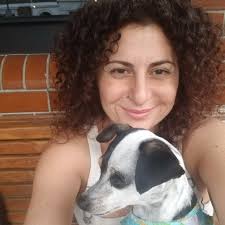 Xenia Kyriakou holding a dog.
