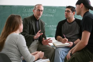 A professor talking to three students