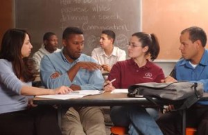 Four students having a discussion in a classroom